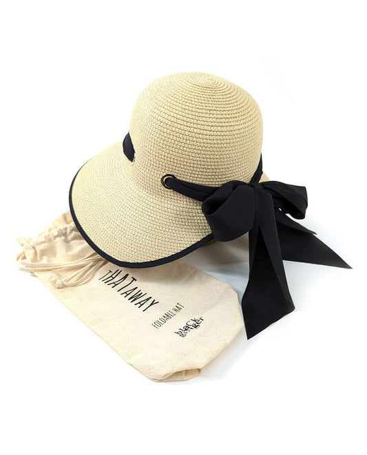 Beige straw hat with black ribbon and drawstring bag on a white background