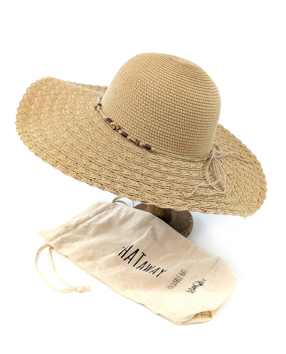 Beige straw hat with decorative band on a white background, accompanied by a 'NATWAY' branded drawstring bag.